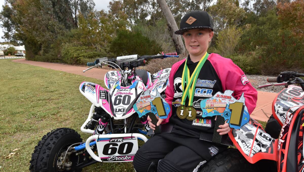 Brooke Hollins shows off her new silverware after the championships. Photo: Justin Rake.