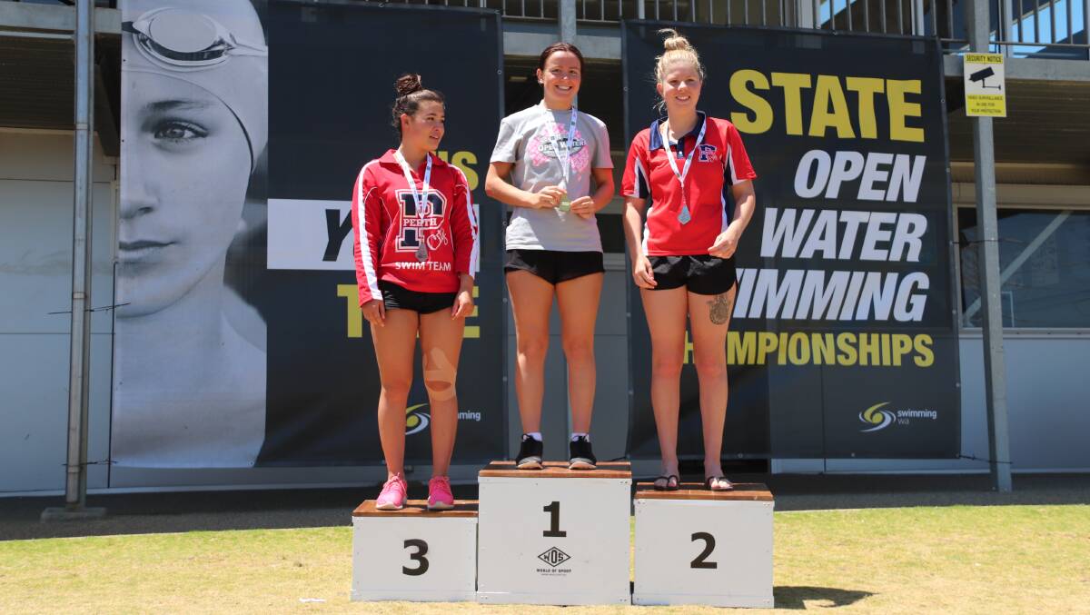 Weller stands atop the podium alongside Josie Page (second) and Caitlin James (third). Photo: Swimming WA/Alice Pearce.