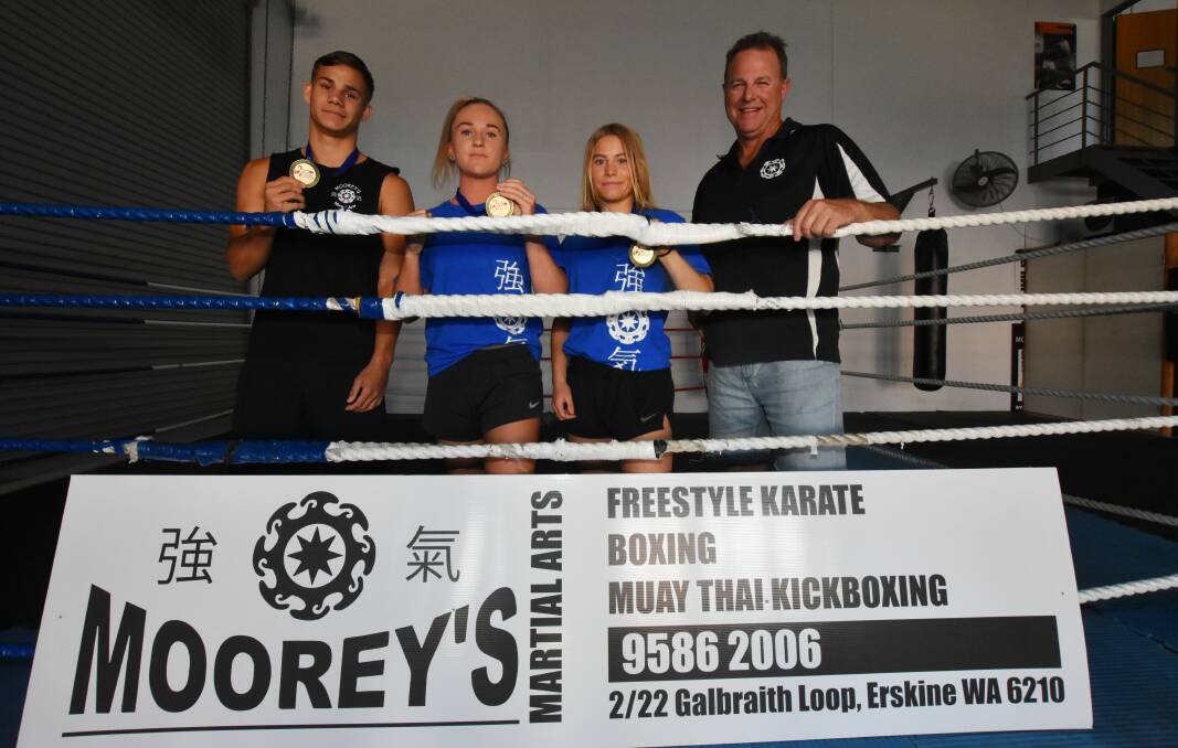 Moorey's Martial Arts fighters Devan Ninyette, Sophie Ingledew and Lucy Robinson, pictured with coach Jason Moore (right), all took out national titles late last month. Photo: Justin Rake. 