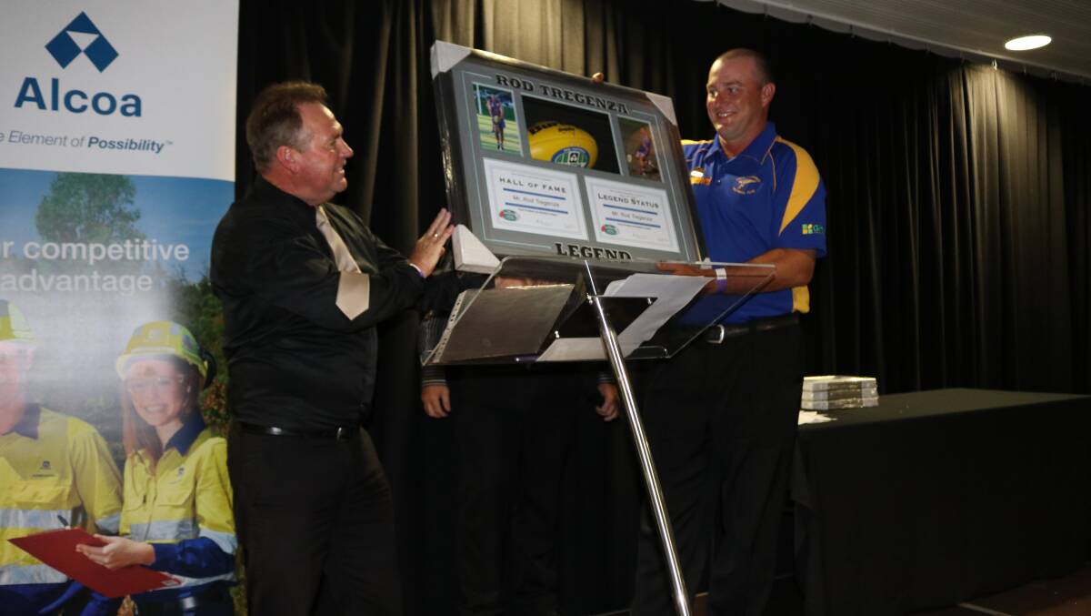 Tregenza being presented with legend status by PFNL general manager Geoff Hiller at the 2018 season launch. Photo: Caitlin Magill.