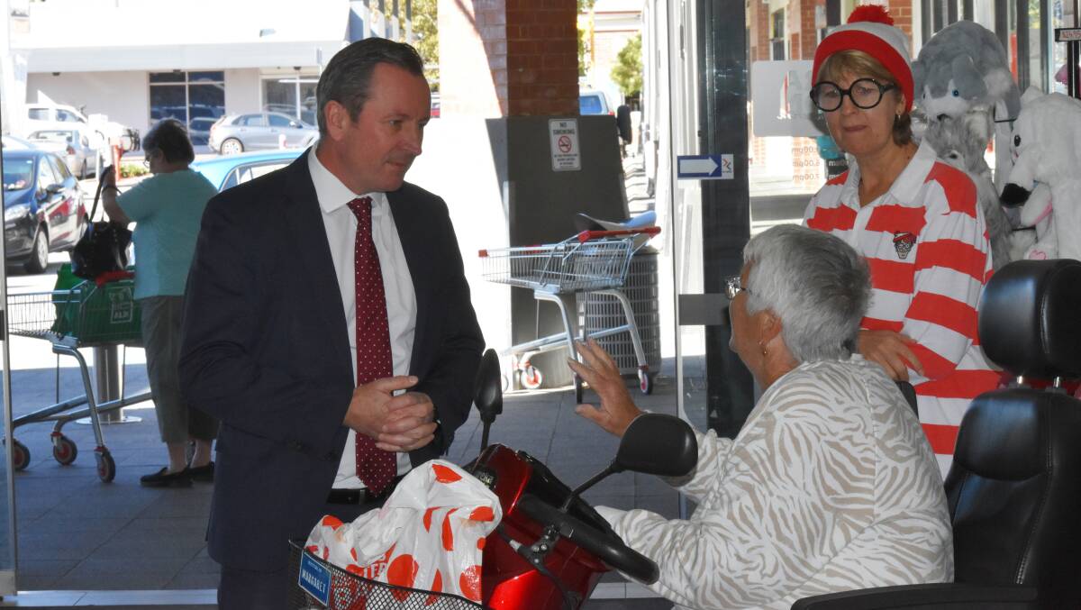 WA Premier Mark McGowan talks with locals at the Pinjarra Junction Shopping Centre on Friday morning. Photo: Justin Rake. 
