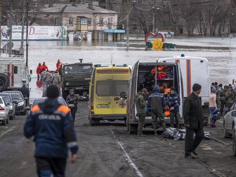 Emergency workers help evacuate residents from flooding in Orsk, Russia. (AP PHOTO)