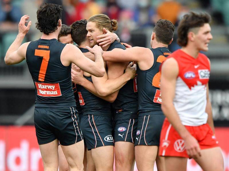 GWS have hung on to defeat the Sydney Swans and keep their hopes of a first AFL flag alive.