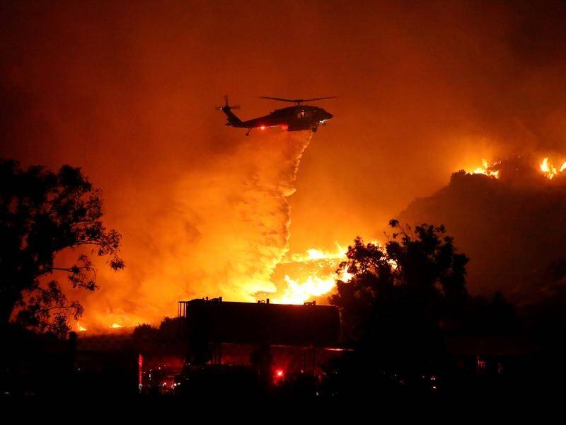 Around 100,000 residents have been evacuated from 23,000 homes as wildfires rage near Los Angeles.