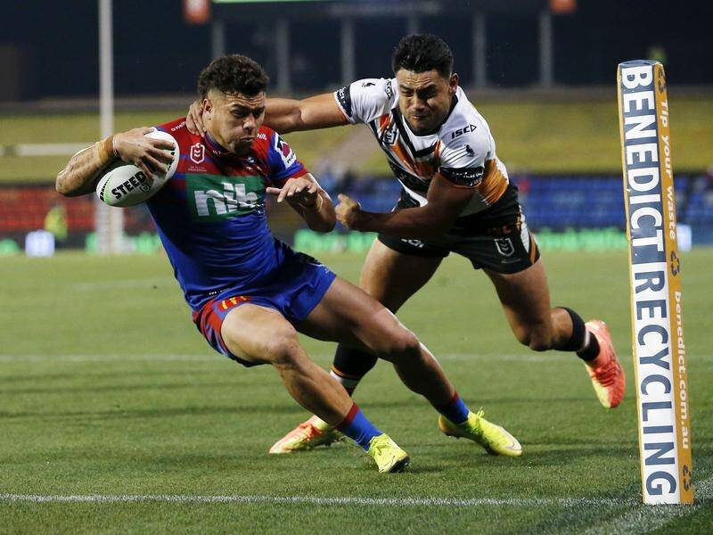 Newcastle's Starford To'a scores a try against Wests Tigers in their 44-4 NRL thrashing on Saturday.