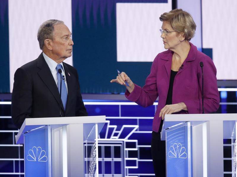 Mike Bloomberg (L) has faced attacks from all Democratic rivals at the Las Vegas debate.