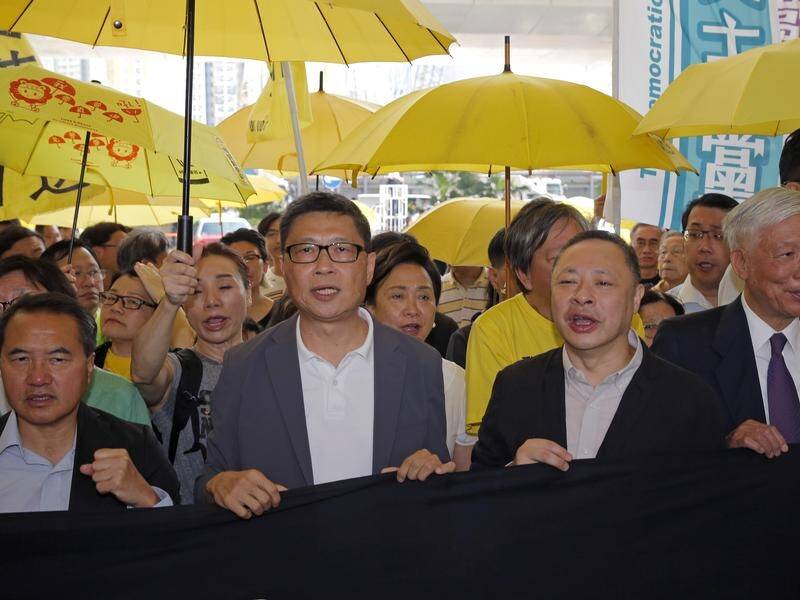 Occupy Central leaders enter a court in Hong Kong for sentencing over 2014 pro-democracy protests.