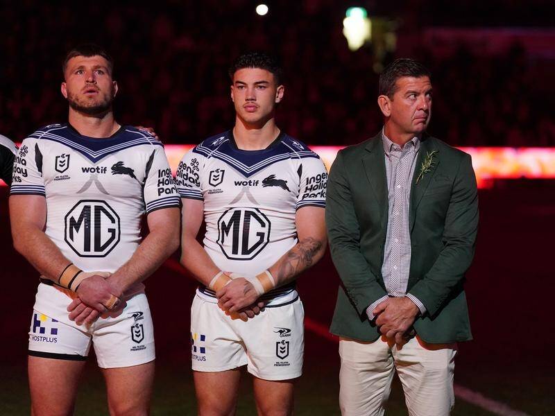 Jason Demetriou (right) stands with the players before the Rabbitohs' Anzac Day loss to Melbourne. (Scott Barbour/AAP PHOTOS)
