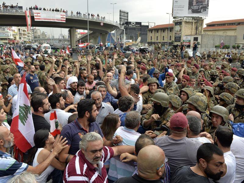 Protesters have clashed with Lebanese soldiers as they tried to open major roads.