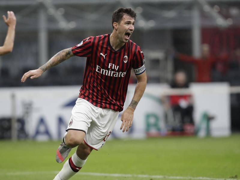 Milan's Alessio Romagnoli celebrates after scoring against Parma at the San Siro stadium.