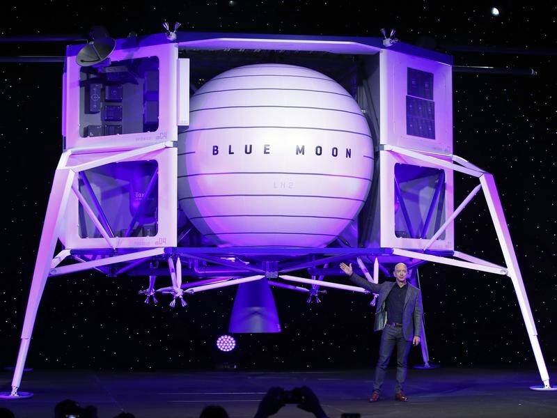 Jeff Bezos speaks in front of a model of Blue Origin's Blue Moon lunar lander.