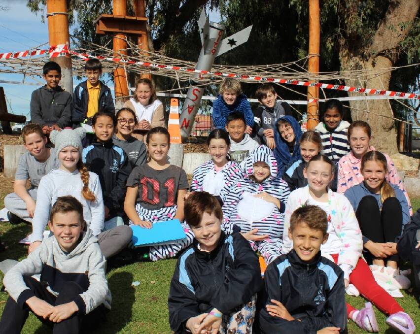 ROCKET KIDS: Year six students from Assumption Catholic Primary School spent their annual PJ Day trying to solve the mystery of NASA 6210. Photo: Supplied
