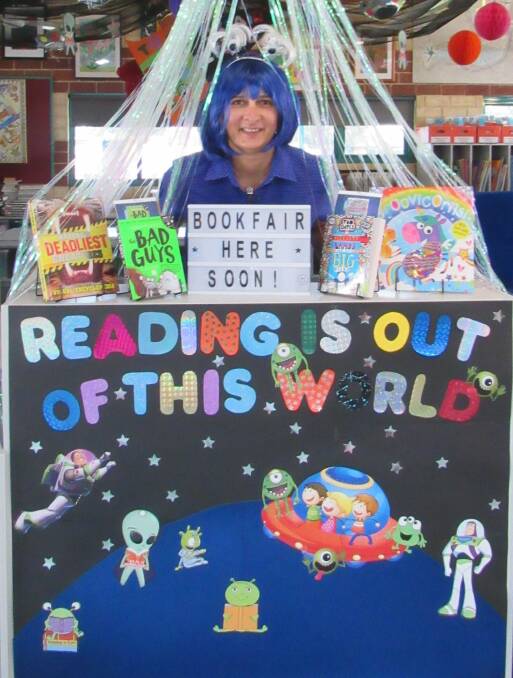 YOU WOULDN'T READ ABOUT IT: Halls Head Primary School library officer Amanda Bishop has been rewarded for her commitment to the library program. Photo: Supplied