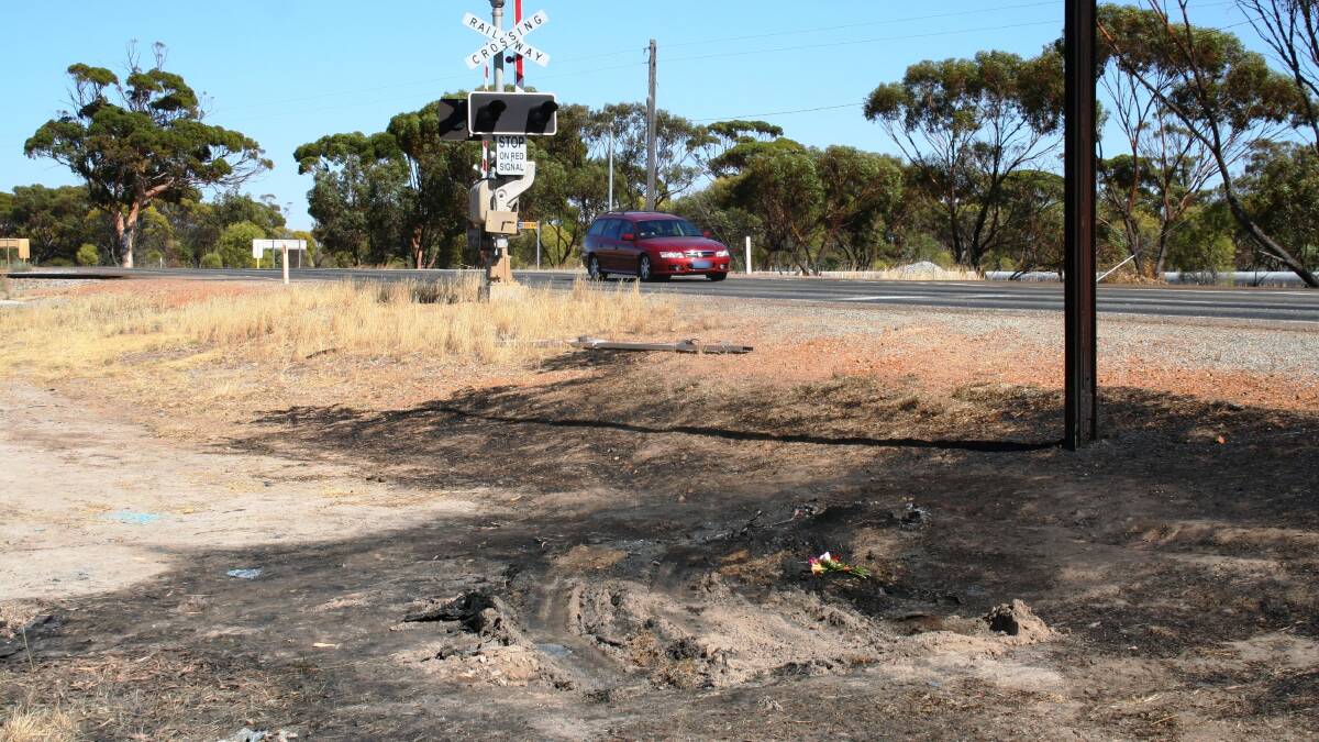 Final stop: Blackened and disturbed soil and flowers mark the spot where the burning car came to rest.