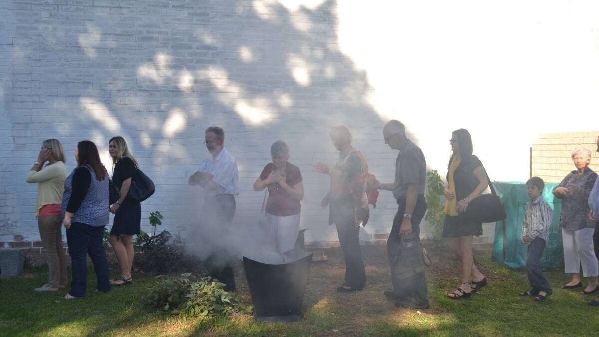 Guests at the ceremony honour Yaburgurt Winjan during the Smoking Ceremony.