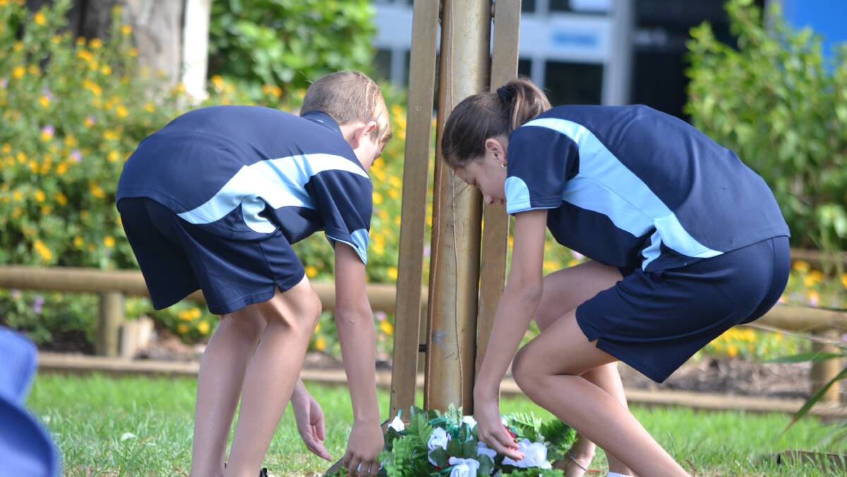 Students lay a wreath.