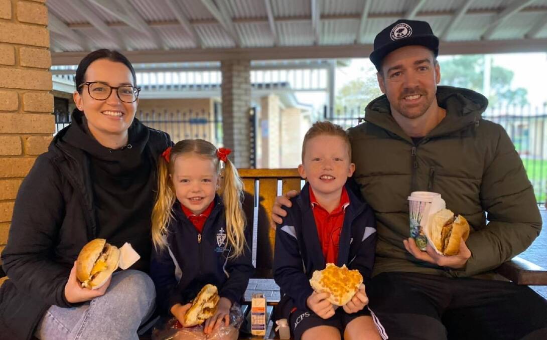 Great start to day: Assumption students Lucy and Oliver Dawson with their parents enjoying a delicious brekkie. Photo: Supplied. 