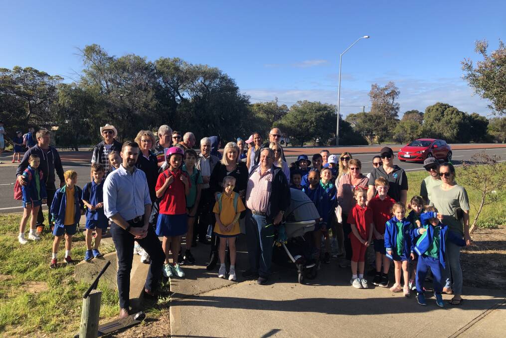 Road safety: MP Zak Kirkup, Falcon Primary School principal Warren Bachman and councillors Jenny Green and Merv Dary, with parents and local residents next to Old Coast Road on National Walk to School Day. Photo: Supplied.