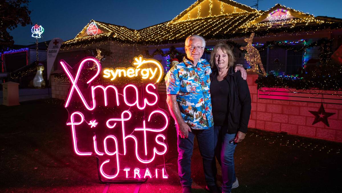 Spreading Christmas cheer: Ron Withnell and his wife Johanna enjoying their Synergy Christmas lights. Photo: Supplied.