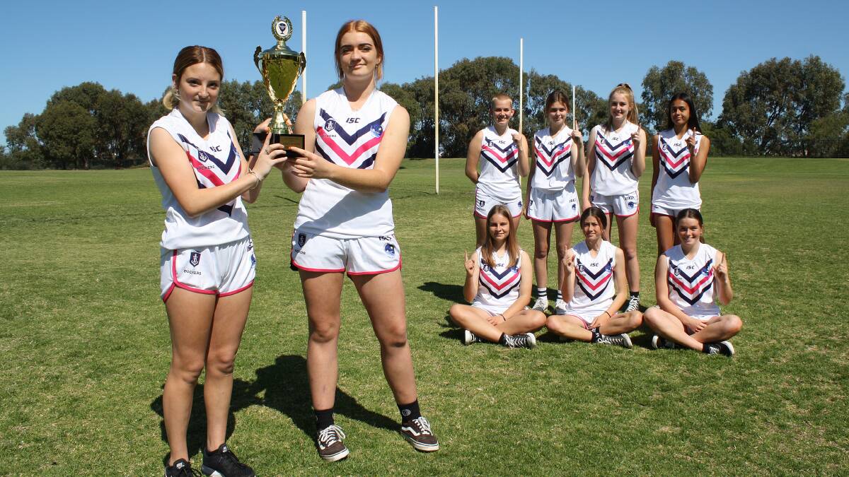 Cup winners: Comet Bay College's Freo Dockers Cup winning team included captain Ashlin Crawford, best on ground Isla Smith and (back row) Lily Ludgate, Isabelle Bailey, Nevaeh Whitlock-Walker, (front row) Keira Campbell, Amanda-Leigh Atkinson and Abbey Poad. Photo: Supplied.