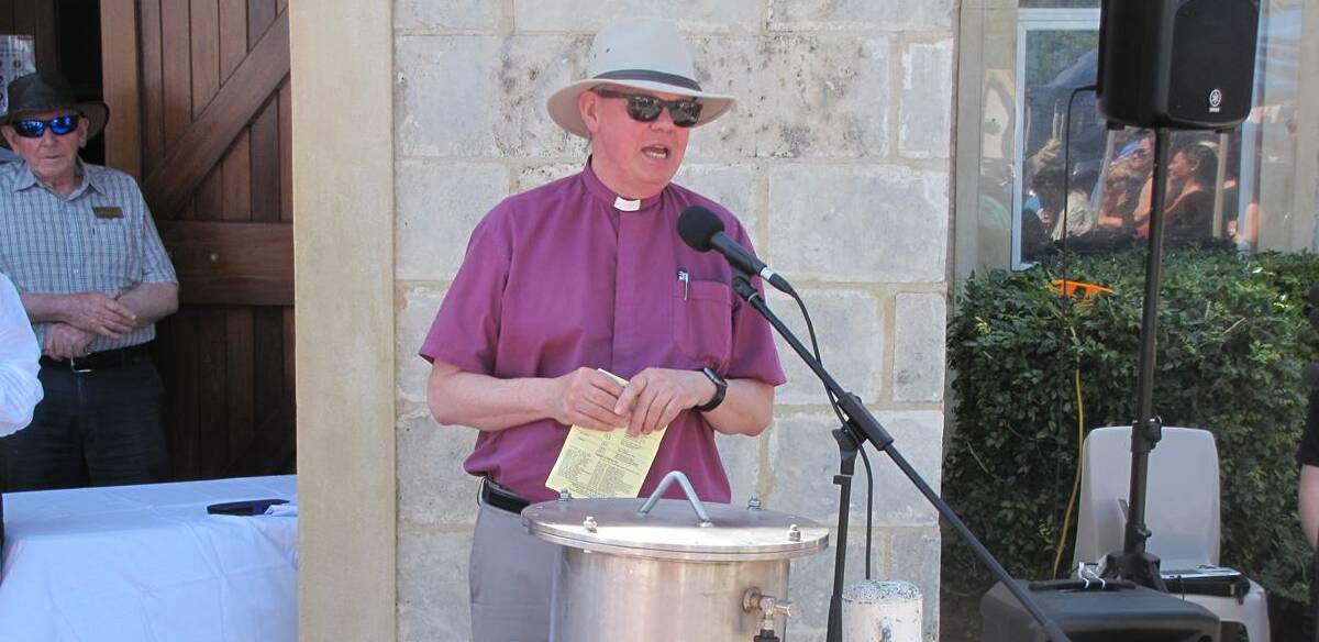 Historic moment: Bishop Ian Coults about to open the time capsule. Photo: Supplied.