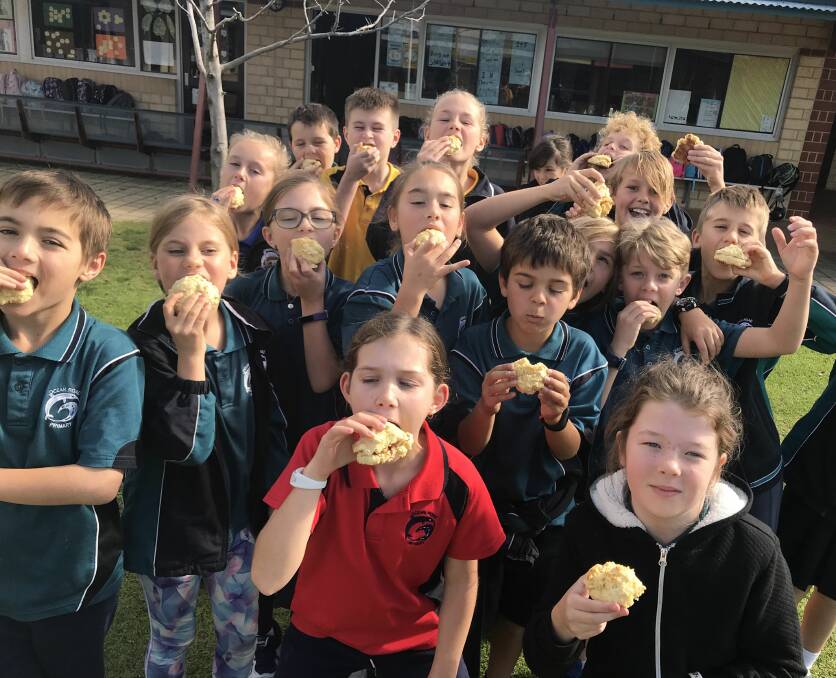 Cultural experiences: Year 4 Ocean Road Primary School students enjoying their damper during NAIDOC Week celebrations. Photo: Supplied.