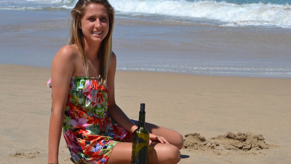 14-year-old Lili Hanley with the bottle she found washed up onshore from Ch...