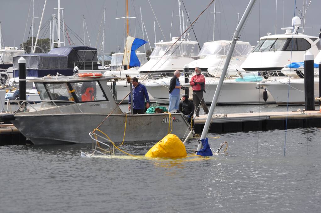 IT WASN'T quite the raising of the Titanic but this morning's operation to float a sunken yacht in Mandurah's Ocean Marina still managed to draw a crowd.